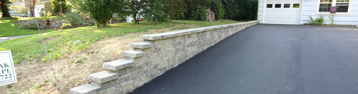 Asphalt driveway stone wall